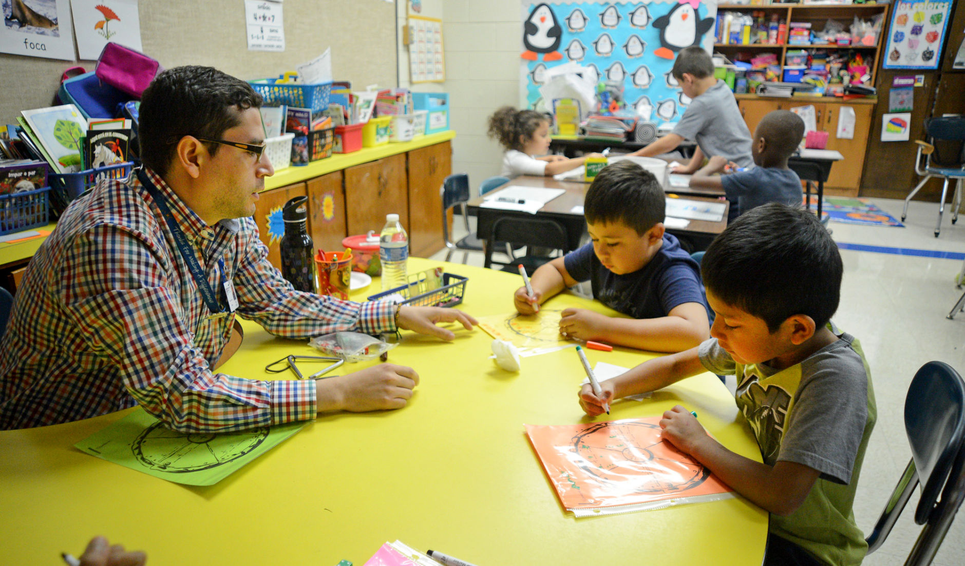 Teacher Andres Lopez-Pira works with first graders at Robbins Elementary School.